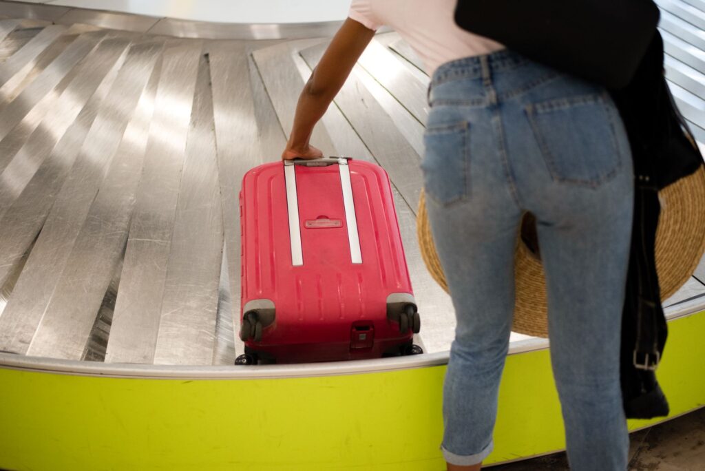 Woman waiting conveyor luggage airport